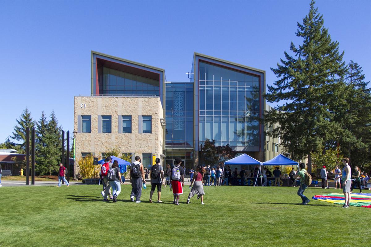 Students walking across the campus commons toward building 13 